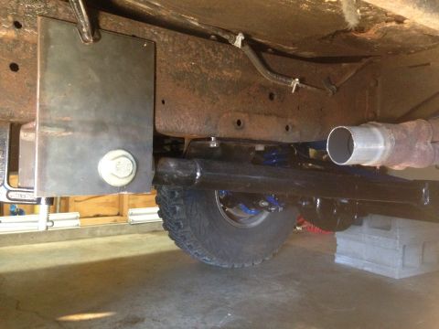 1979 Ford Bronco - Close-up of vehicle undercarriage, focusing on suspension and exhaust system parts.