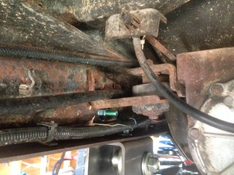1979 Ford Bronco - Close-up view of aged suspension components and wiring, showing signs of rust and wear.