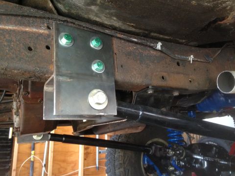 1979 Ford Bronco - Custom suspension bracket with green bolts is attached to the vehicle's frame.