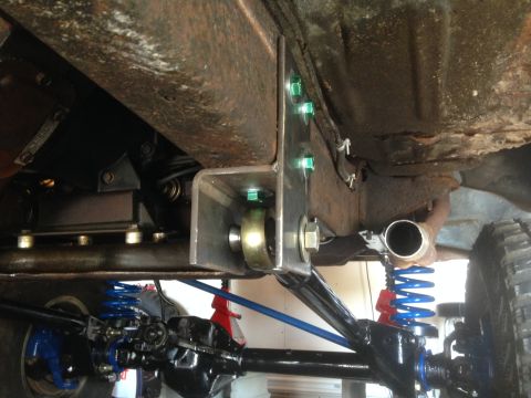 1979 Ford Bronco - Custom suspension bracket installed on a vehicle frame, with new springs and axle visible.