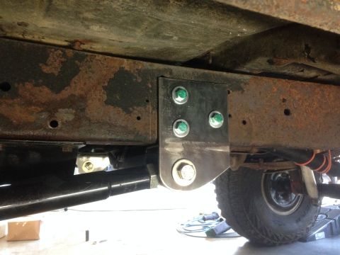 1979 Ford Bronco - Close-up of a custom suspension bracket installed on the frame of a 1979 Ford Bronco.