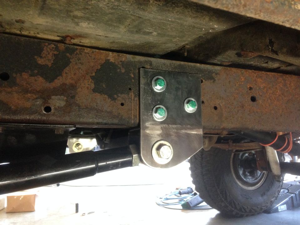 1979 Ford Bronco underbody suspension bracket with green-capped bolts