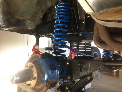 1979 Ford Bronco - Vehicle suspension system with new blue coil springs and brake components visible.