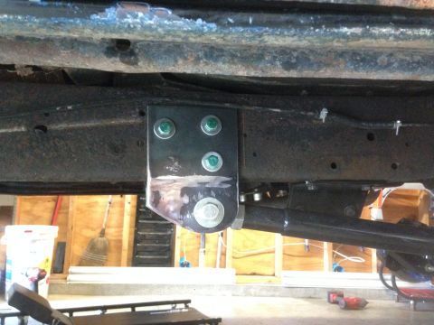 1979 Ford Bronco - Close-up view of a custom suspension bracket attached to a vehicle's frame.