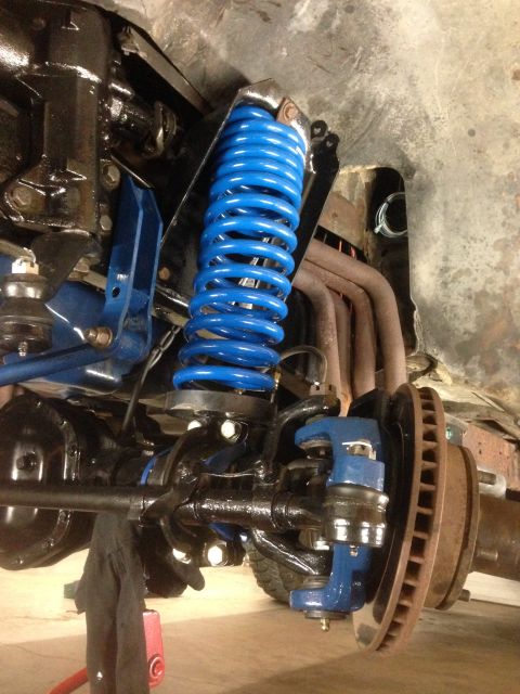 1979 Ford Bronco - The image shows a close-up view of a vehicle's suspension system, highlighting new blue springs and other components.