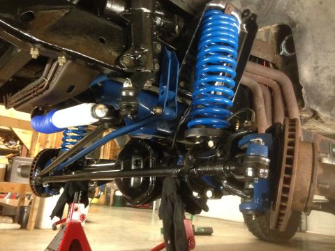 1979 Ford Bronco - Close-up view of the front suspension system of a 1978 Ford Bronco, showing newly painted components.