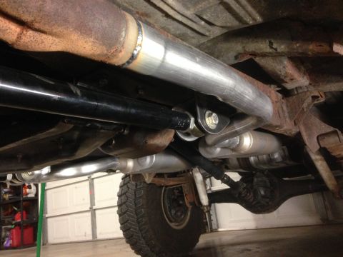 1979 Ford Bronco - New exhaust system installed on a 1979 Ford Bronco, showing the underside and suspension.