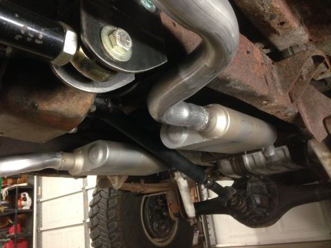 1979 Ford Bronco - The photo shows the underside of a vehicle, focusing on the exhaust system and suspension components.