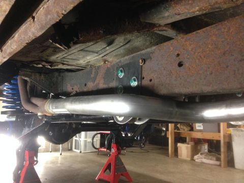 1979 Ford Bronco - The vehicle's undercarriage is visible, with a focus on the frame and suspension system.
