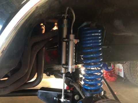 1979 Ford Bronco - Vehicle suspension components including a blue coil spring and dual shock absorbers are visible.