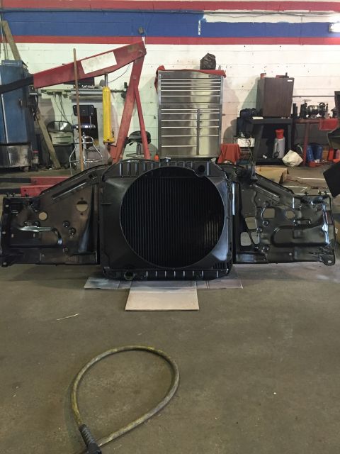 1978 Ford Bronco - Vehicle radiator and front clip assembly removed and placed on the garage floor.