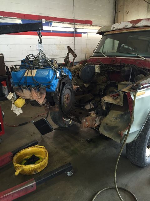 1978 Ford Bronco - Engine removal in progress on a 1978 Ford Bronco in a garage setting.
