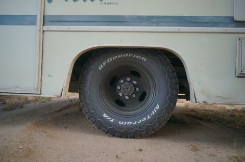 1995 Chevrolet P30 1 Ton - Step Van - Close-up of a van's wheel and fender, showing the tire and part of the vehicle's body.