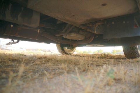 1995 Chevrolet P30 1 Ton - Step Van - Undercarriage of a large van or truck, focusing on the exhaust and a tire.