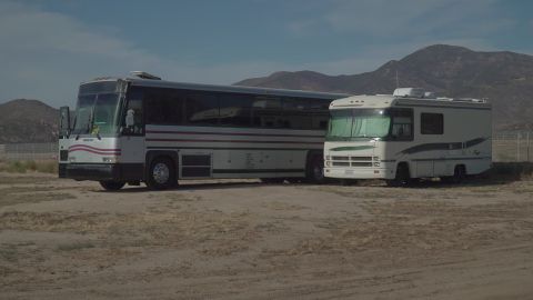 1995 Chevrolet P30 1 Ton - Step Van - Two recreational vehicles are parked next to each other in an outdoor lot with mountains in the background.