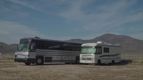 1995 Chevrolet P30 1 Ton - Step Van - Two RVs, a large bus and a motorhome, are parked side-by-side in a desert landscape.