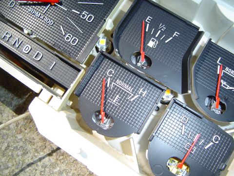 1986 Ford Bronco - Close-up of a vehicle's instrument cluster gauges, including tachometer, fuel, and temperature indicators.