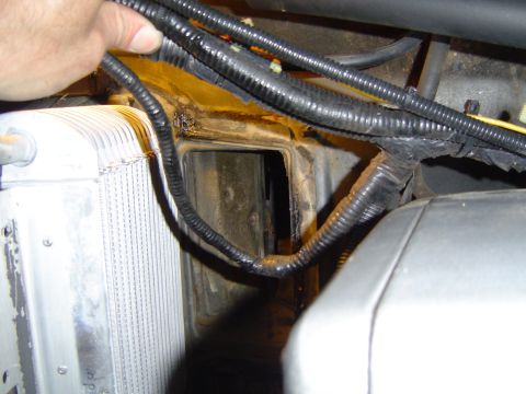 1986 Ford Bronco - Close-up view of wiring and radiator components within an engine bay.