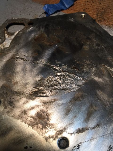 1978 Ford Bronco - This metal part shows significant damage and wear, with rough patches and visible scratches.