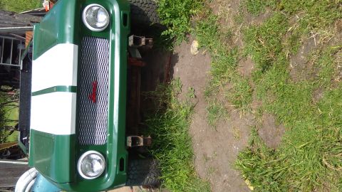 1991 Ford Bronco - This green SUV features distinctive white stripes on its hood and a prominent diamond-patterned grille.