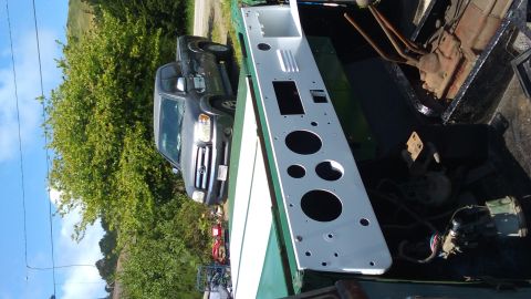 1991 Ford Bronco - A gray pickup truck is visible next to a green vehicle's interior, which has a white dashboard panel.