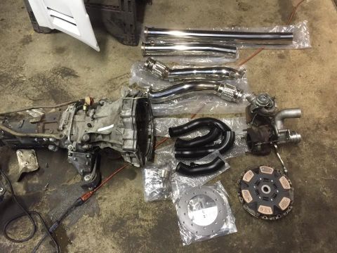 2001 Audi S4 - Various automotive components, including a transmission and turbocharger, are arranged on the ground.