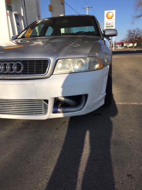2001 Audi S4 - The front of a silver Audi S4 is visible, an aftermarket intercooler and piping under a primer-finished bumper.