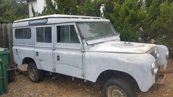 Land Rover Series III with a custom hardtop, primer grey paint, parked outdoors