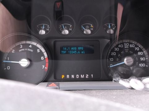 2011 Ford F-250 - The vehicle's interior dashboard displays various gauges and a digital readout showing average MPG and mileage.