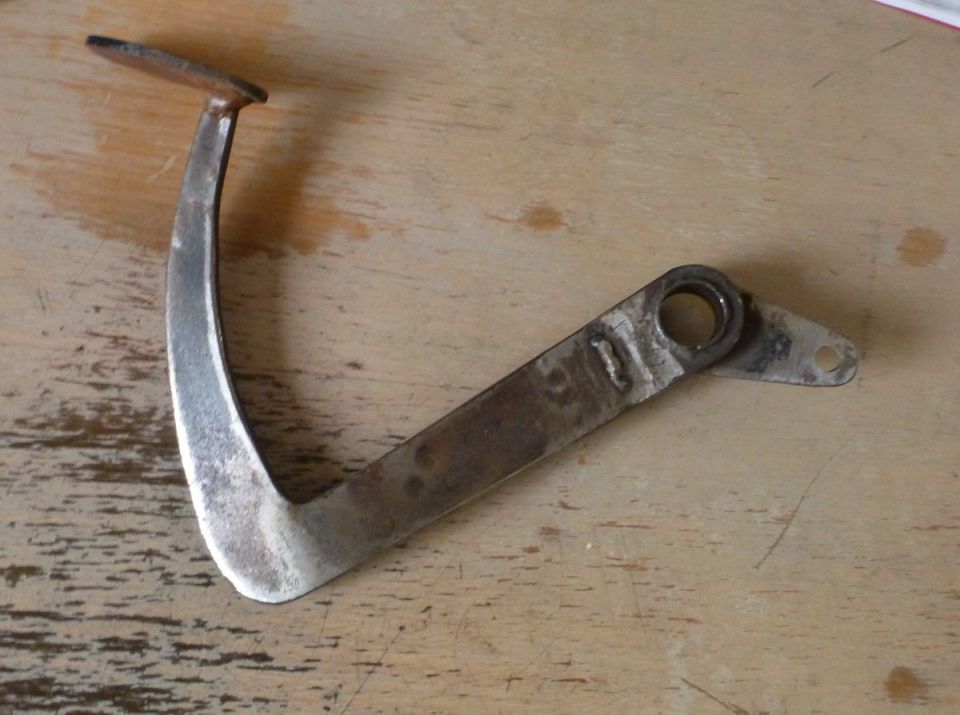 Metal bracket with a curved arm and a flat extension