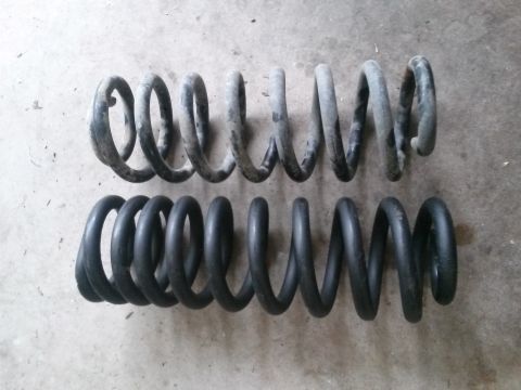 1996 Ford Bronco - Comparison of a used coil spring next to a new one.