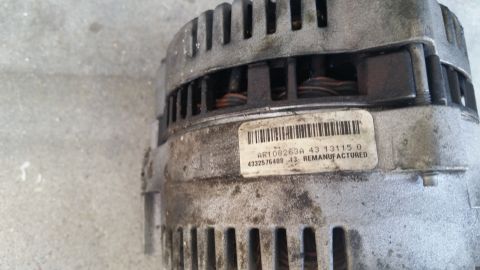 1992 Ford Bronco - A remanufactured alternator is shown with a part number and barcode on its label.