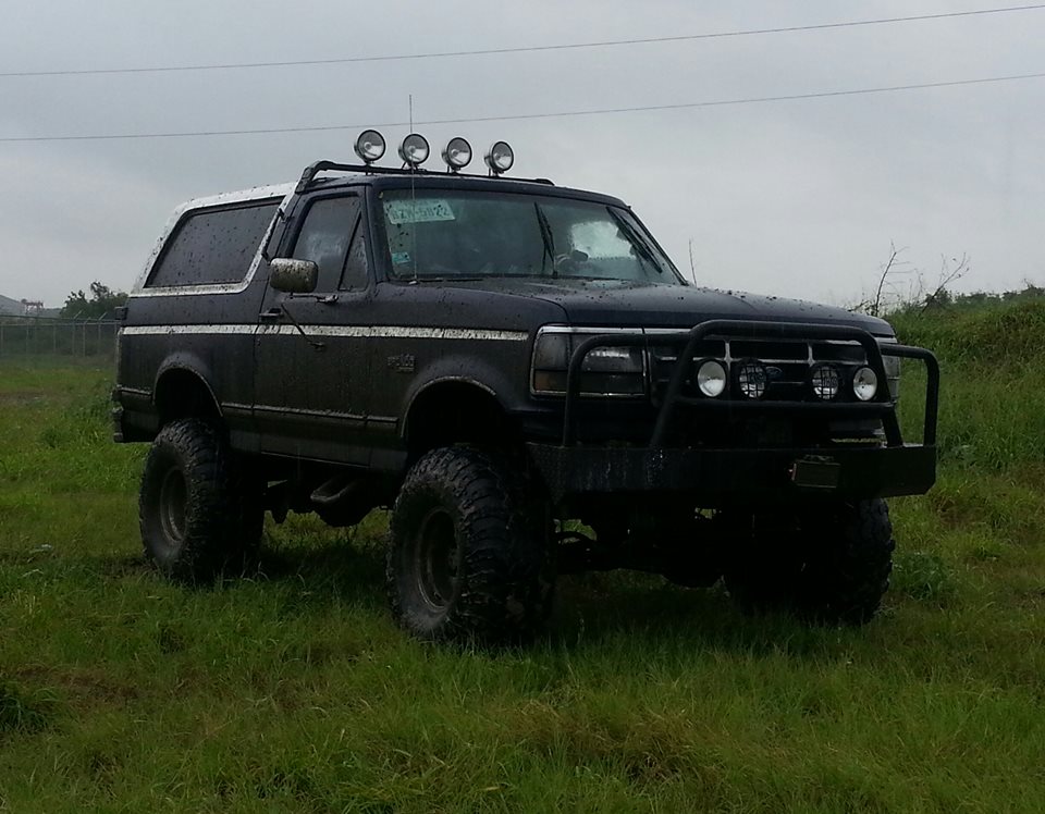 Black Ford Bronco with off-road lights on roof and brush guard