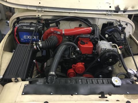 1986 Jeep Wagoneer - Customized Jeep engine bay features a prominent turbocharger and updated components.