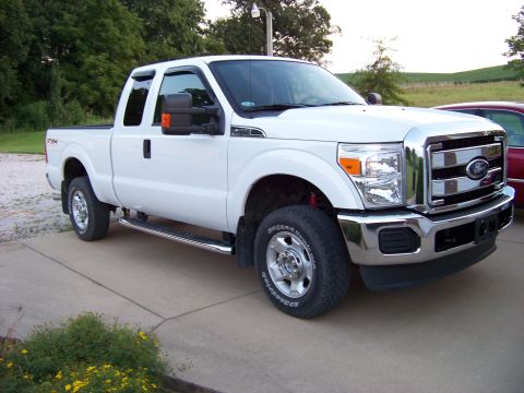2011 Ford F-250 - This white 2011 Ford F-250 pickup truck is shown from a 3/4 front angle.