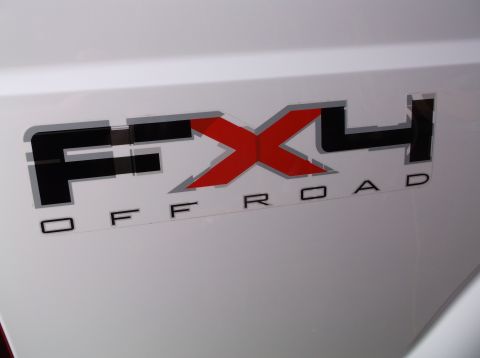 2011 Ford F-250 - Close-up of the FX4 Off Road badging on a white Ford truck.