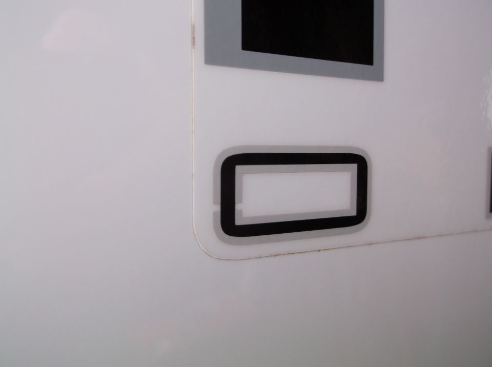 Close-up of a white vehicle panel with black and gray trim detail. Supermotors.net logo visible
