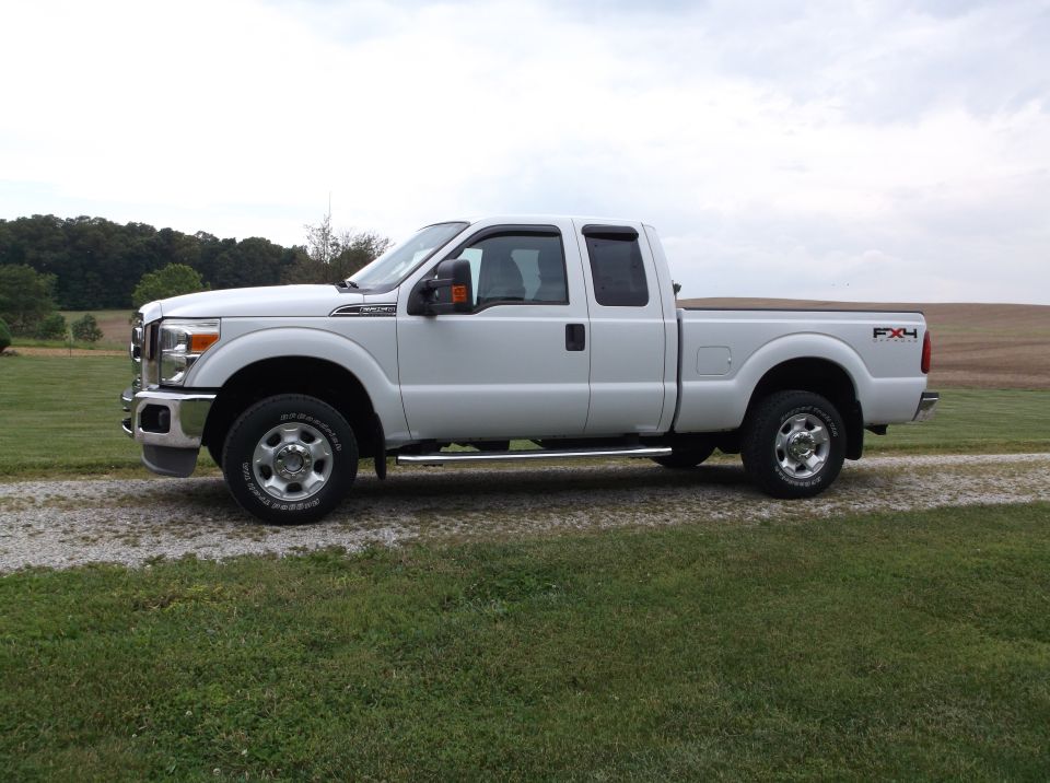 White 2011 Ford F-250 Super Duty pickup truck, side view