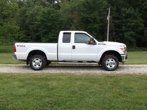 2011 Ford F-250 - Side view of a white 2011 Ford F-250 Super Duty pickup truck.