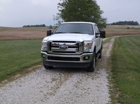 2011 Ford F-250 - Front view of a white 2011 Ford F-250 Super Duty pickup truck on a gravel drive.