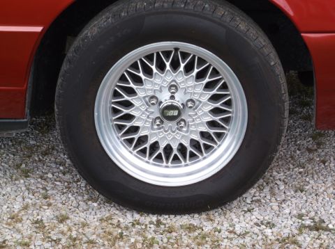 1999 Mercury Grand Marquis - A close-up view of a car's wheel a distinctive BBS rim and tire.