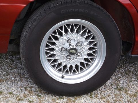 1999 Mercury Grand Marquis - Close-up of a red vehicle's wheel BBS rims and Pirelli Cinturato tires.