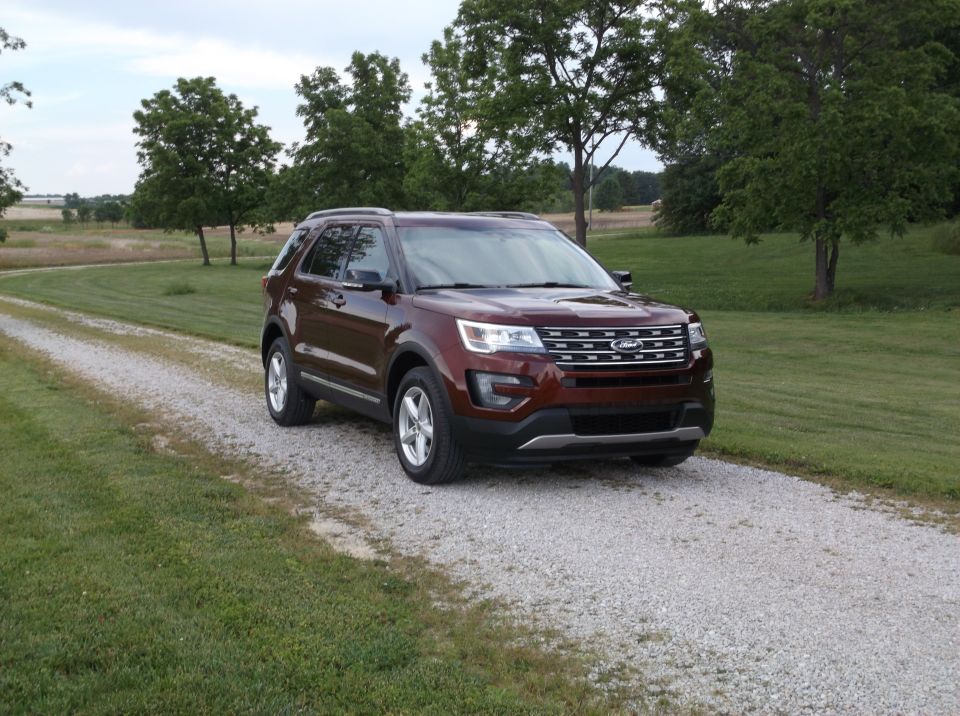 Brown 2016 Ford Explorer on a gravel driveway, front 3/4 view