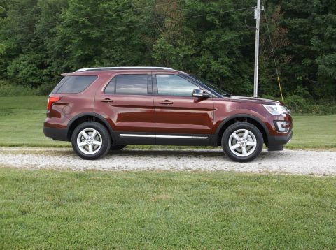2016 Ford Explorer - 2016 Ford Explorer parked on gravel with trees in the background.