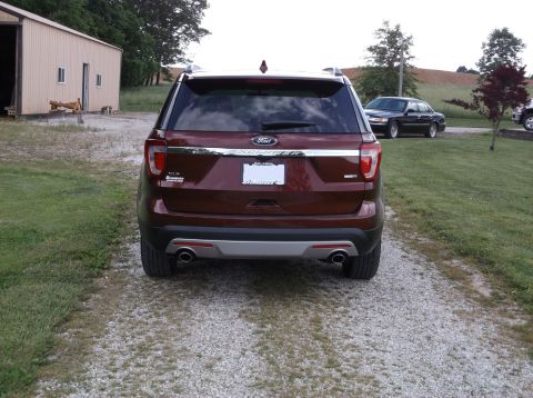 2016 Ford Explorer - Rear view of a maroon 2016 Ford Explorer parked on a gravel driveway with a barn in the background.