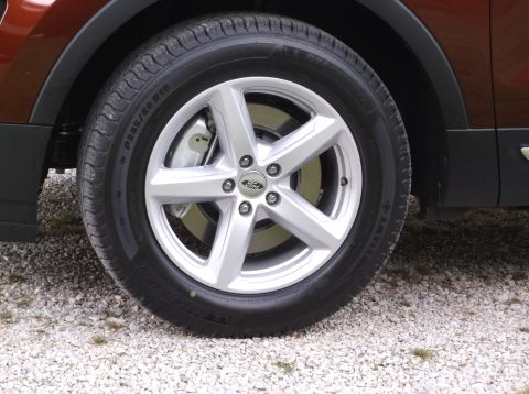 2016 Ford Explorer - Front wheel and tire assembly on a 2016 Ford Explorer. The alloy wheel features a five-spoke design with the Ford emblem.