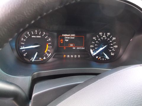 2016 Ford Explorer - Dashboard display shows a driver door ajar warning and 72.8 miles on the odometer.