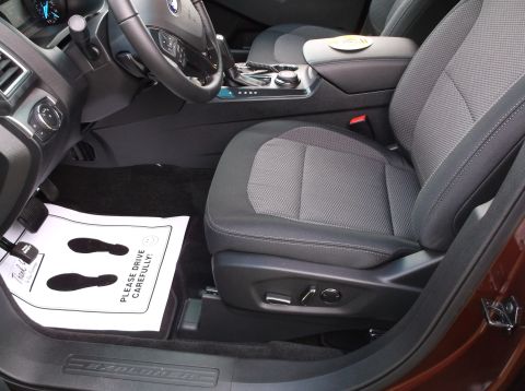 2016 Ford Explorer - The interior of a 2016 Ford Explorer, the driver's seat, dashboard, and a floor mat with footprints.