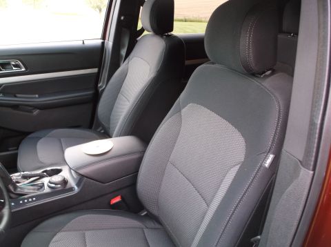2016 Ford Explorer - Interior view of car seats and center console with a CD on the armrest. The registry label may be incorrect.