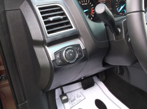 2016 Ford Explorer - Interior view of a vehicle's dashboard, showing the driver's side controls and floor mats.